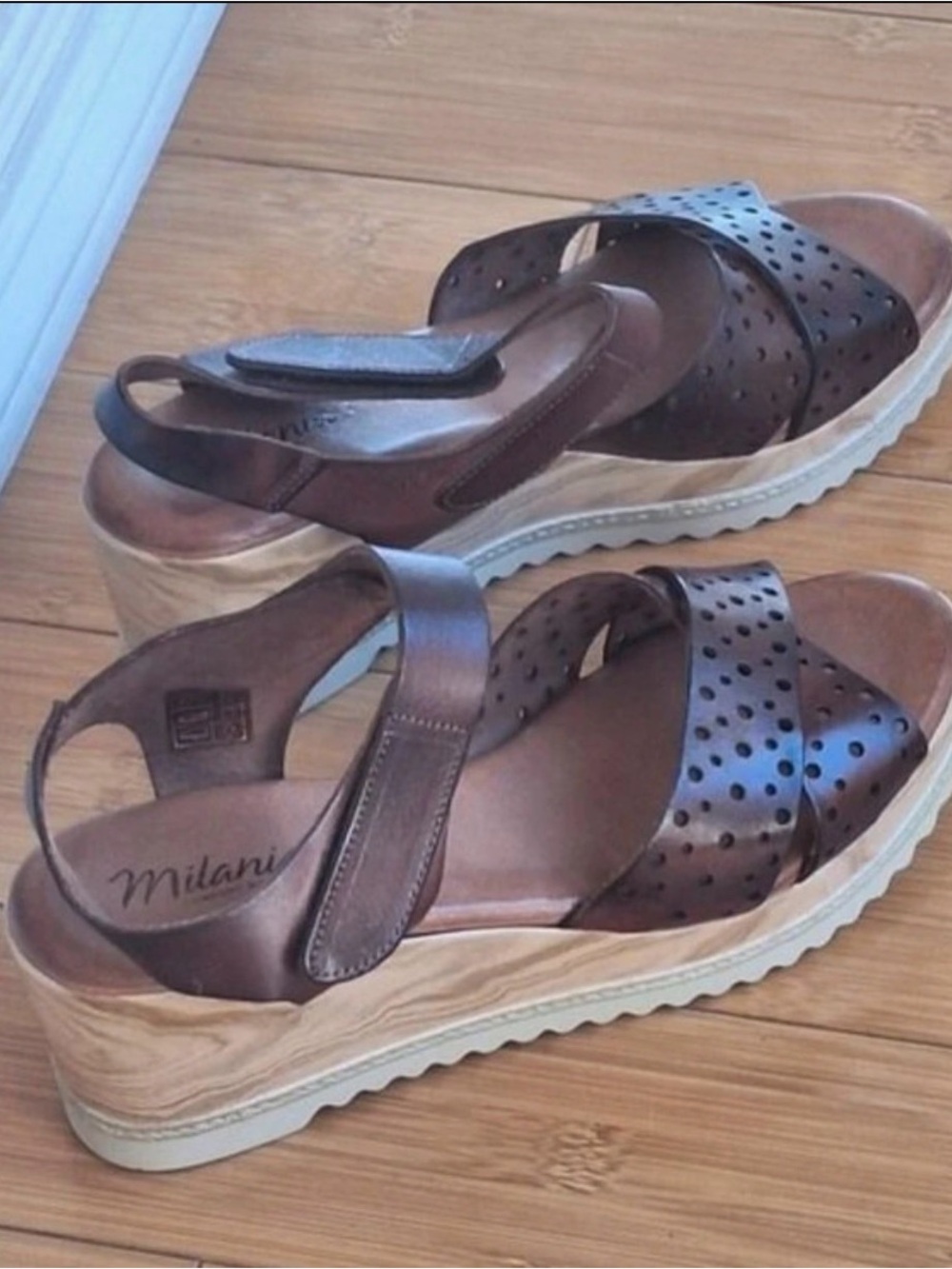 Milania’s Brown Perforated Leather Wedge Sandals with Wood-Effect Platform